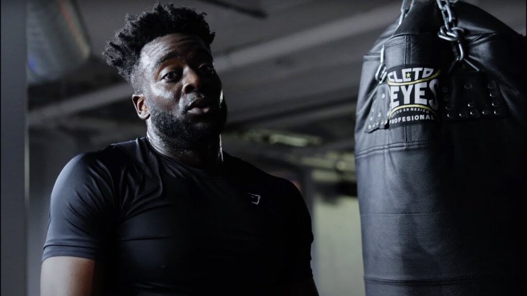 Man next to punch bag in a boxing gym